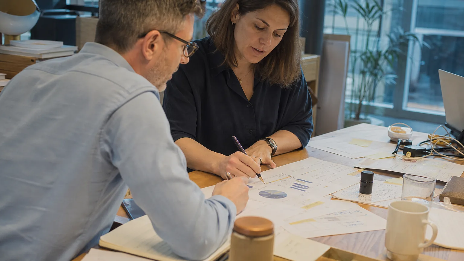 Finance lead and marketing manager reviewing a monthly marketing budget together